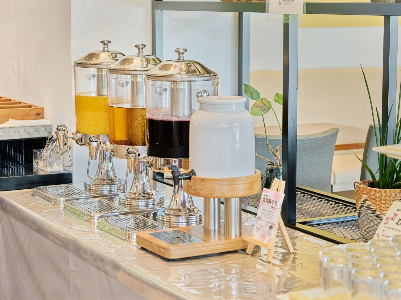 A beverage station with multiple dispensers, a coffee machine, and a menu stand.