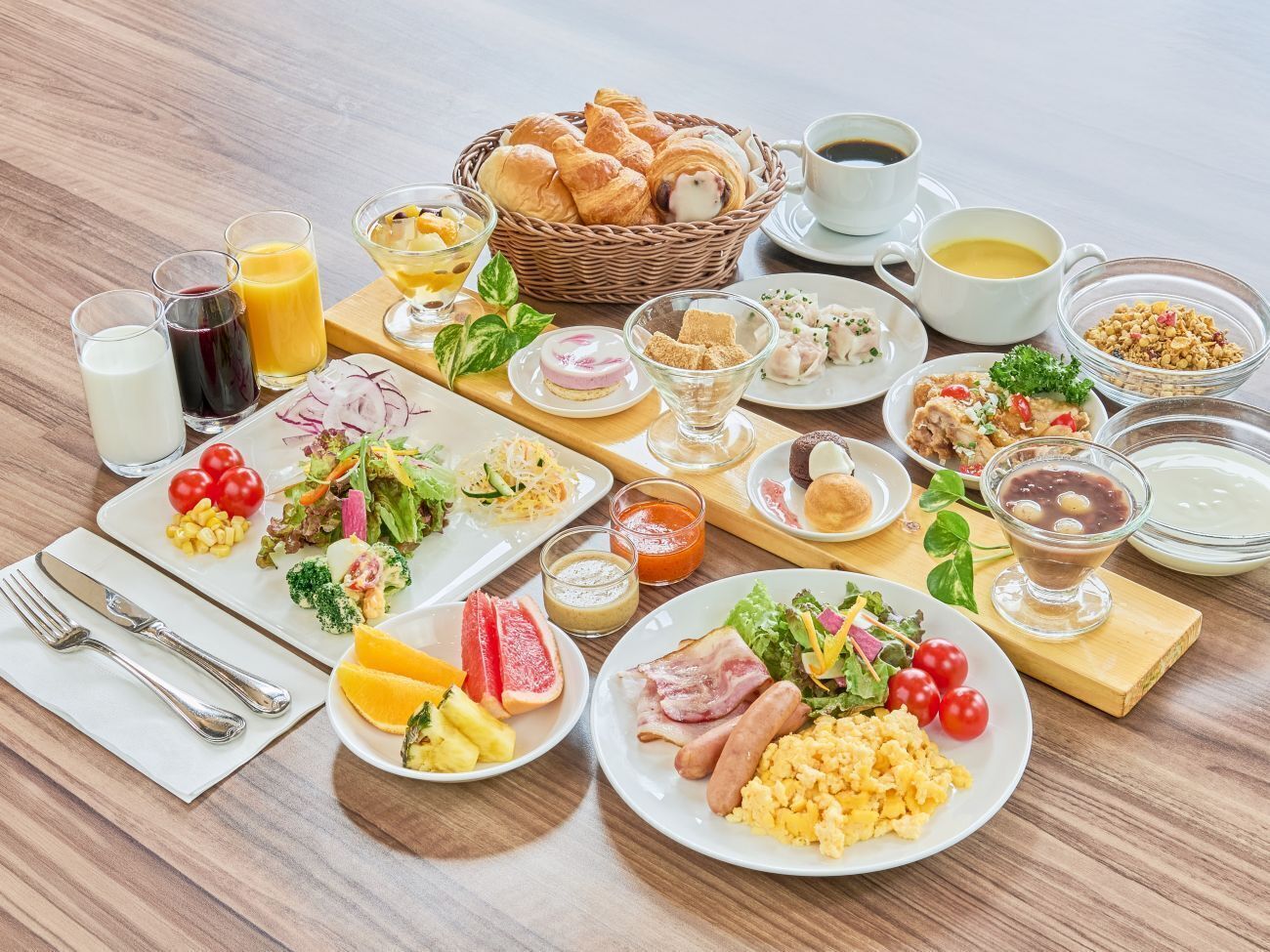 A breakfast buffet with various dishes, drinks, and bread.