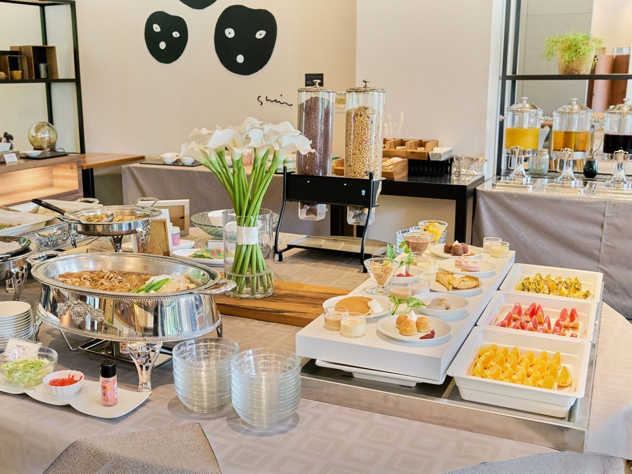 A buffet setup with various food items and beverages.