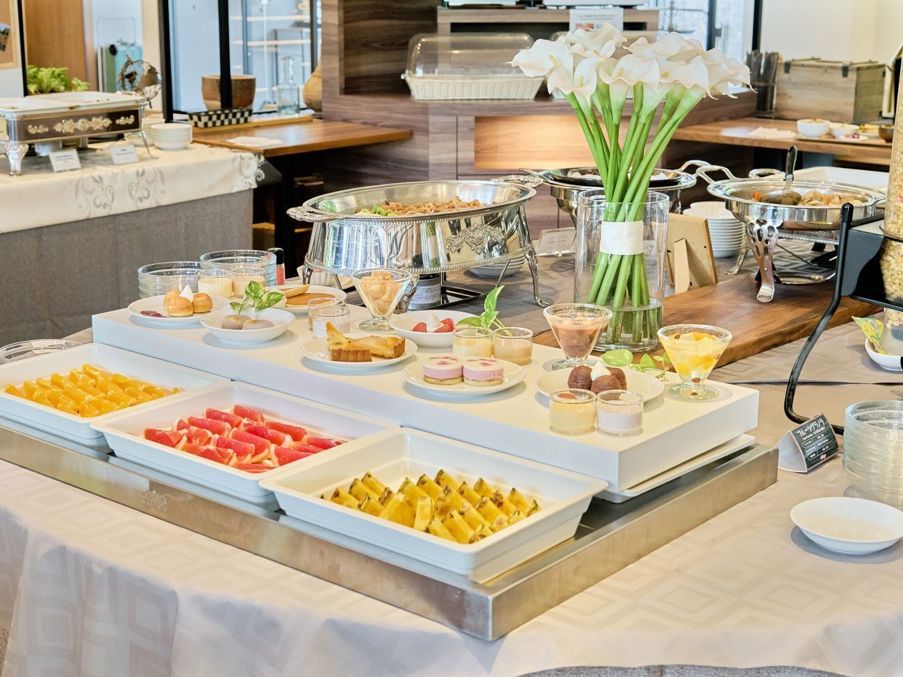 A buffet setup with various food items and drinks.