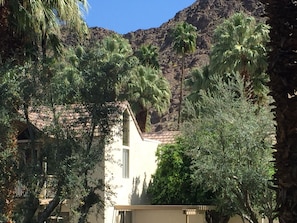 Set amidst lush greenery and a mountainous backdrop, this traditional building offers a serene escape.