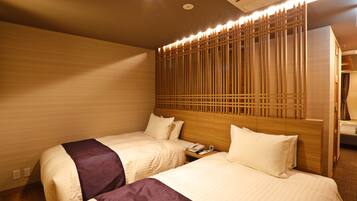 A hotel room with two beds, a wooden headboard, a nightstand, and a wall-mounted air conditioner.