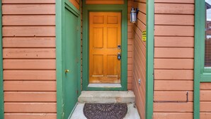A wooden house with a green door and a doormat. - 2 Mi to Frisco Ski Hill: Mountain Home w/ Hot Tub! (Frisco)