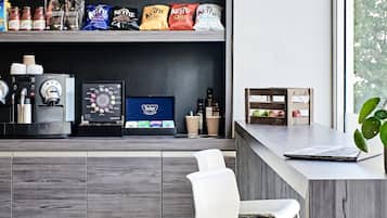 A modern coffee bar with a variety of coffee beans, a display of Tetley tea, and a Nespresso machine.