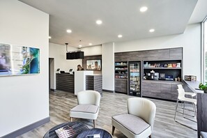 A modern hotel lobby with a reception desk, seating area, and a bar. - Citadines City Centre Liverpool (Liverpool)