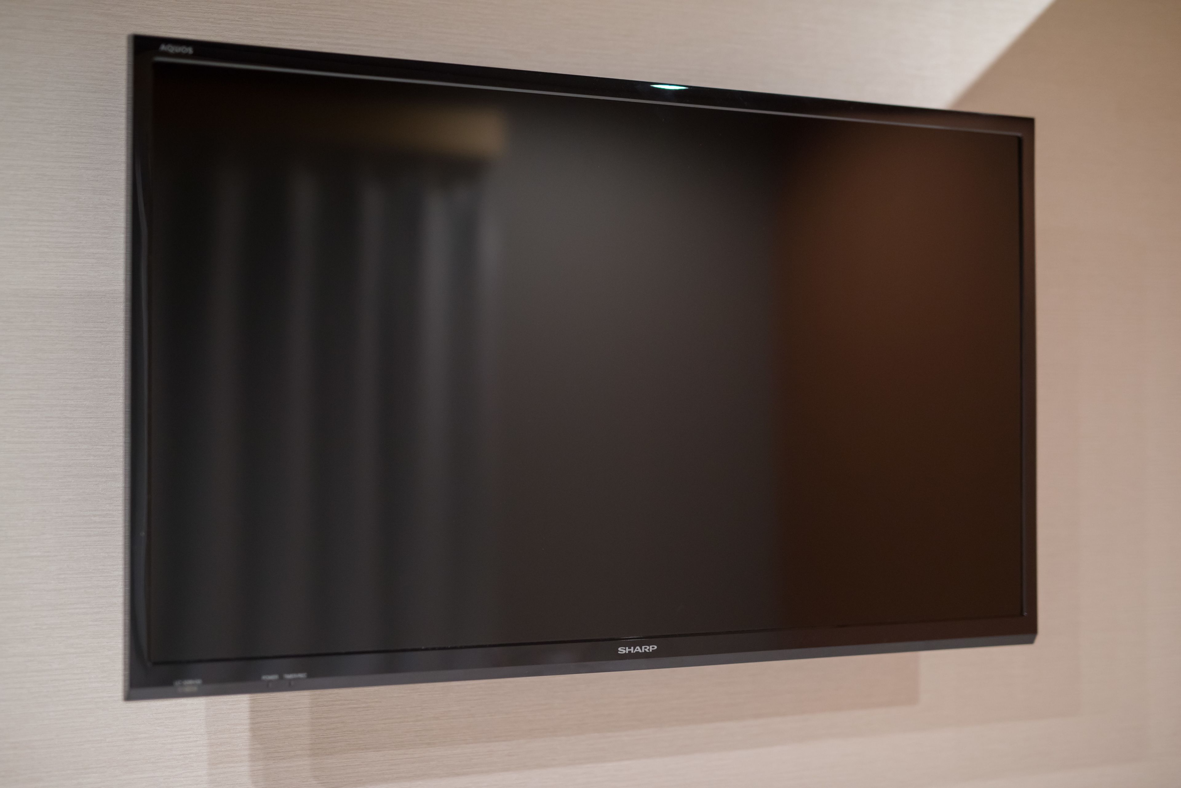 A flat-screen TV mounted on a wall.
