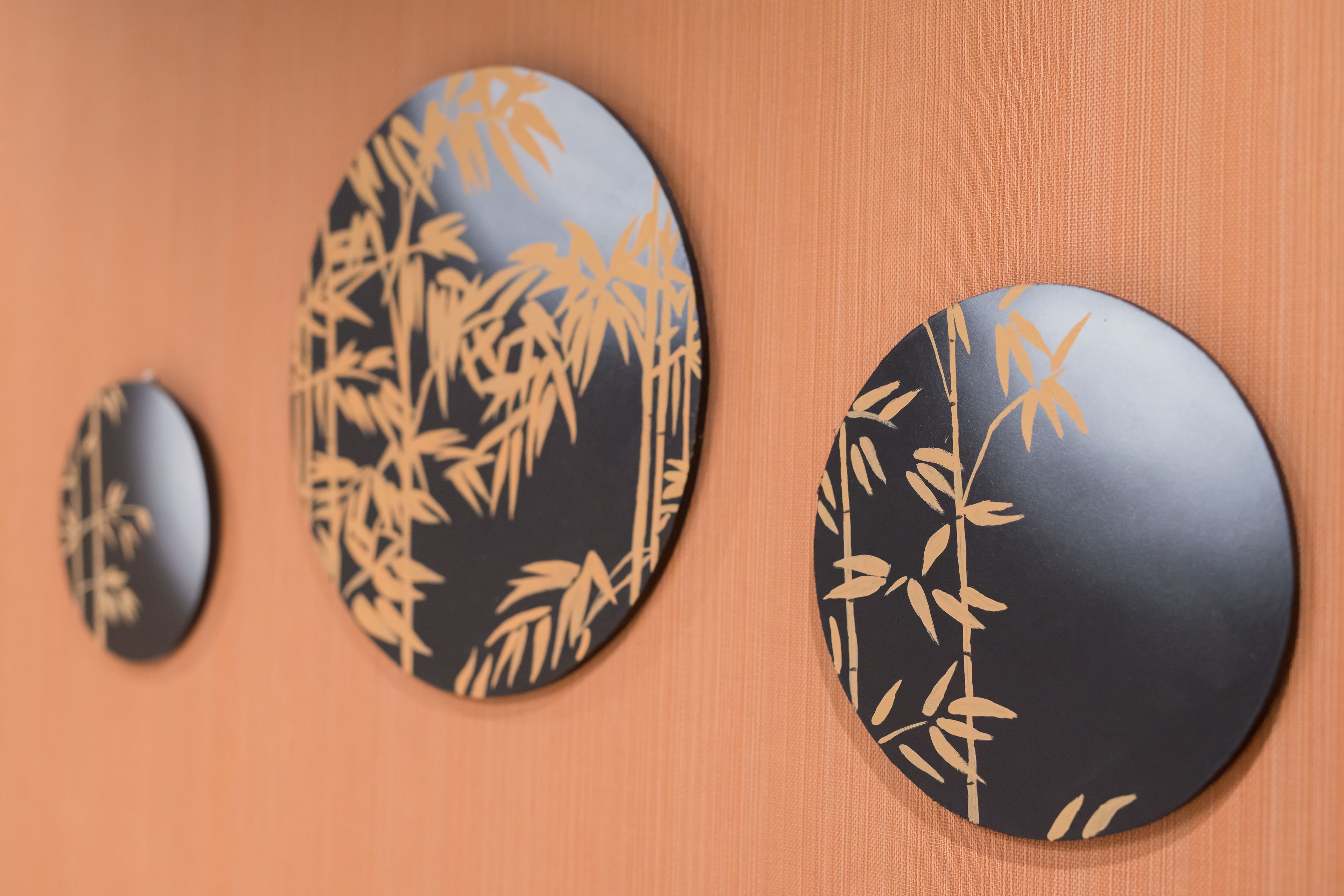 Three circular wall decorations with bamboo patterns.