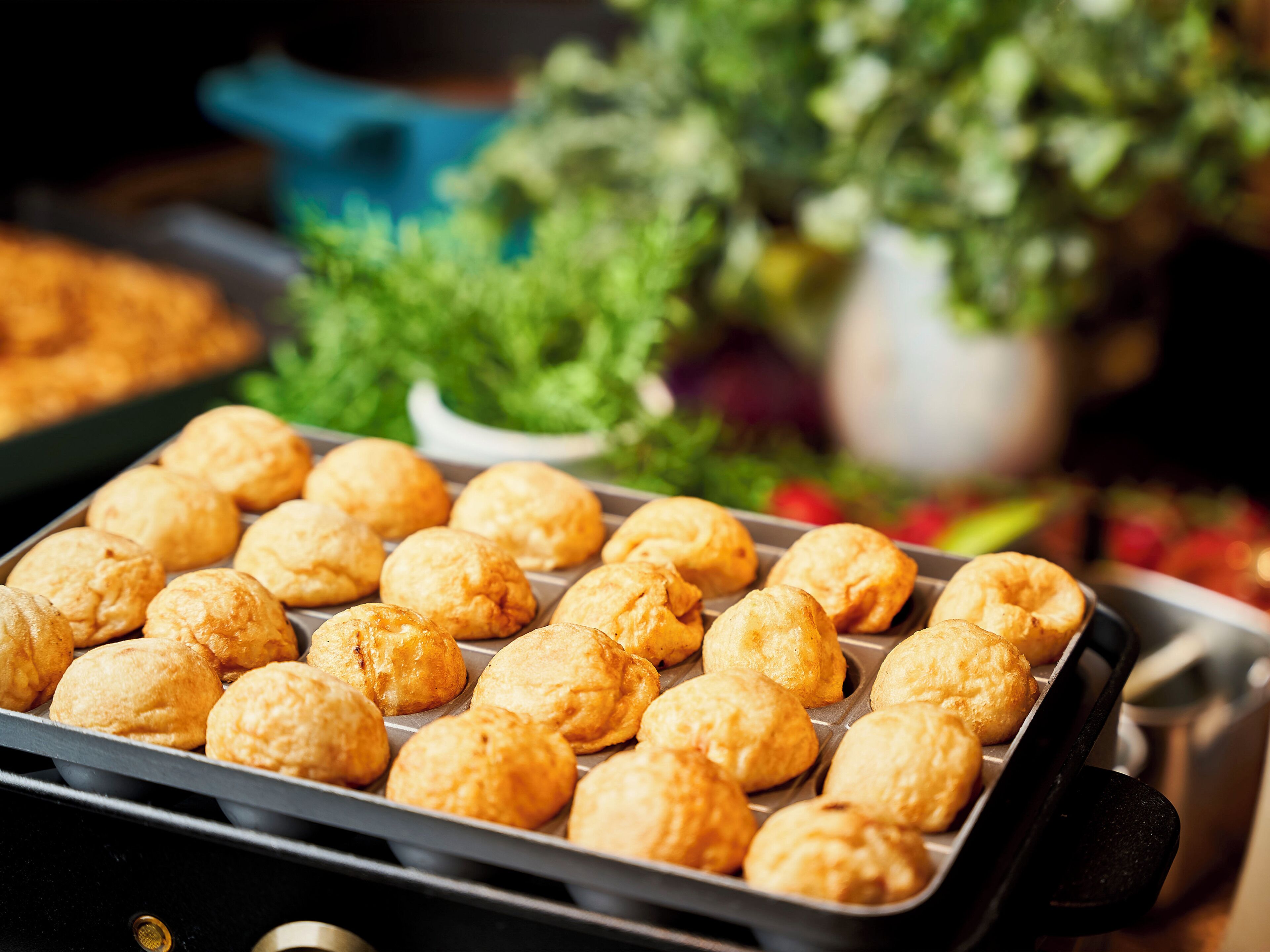 A tray of freshly baked pastries in a kitchen setting.