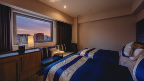 A hotel room with a large window, a bed, a sofa, a desk, and a lamp. - HOTEL GRACERY Osaka Namba (Osaka)