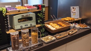 A buffet with various food items including fruits, pastries, and bread. - HOTEL GRACERY Osaka Namba (Osaka)