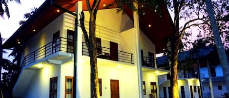 A two-story building with a balcony and a staircase.