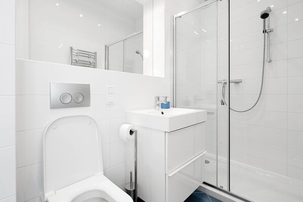 Shower, hair dryer, towels, toilet paper