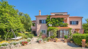 A two-story house with a garden entrance, a swing, and potted plants. - 2 bedroom cozy apartment in Krasica (Krasica)