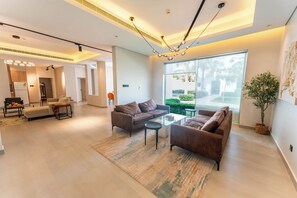 Grand Villa, 3 Bedrooms | Living area | 50-inch Smart TV with satellite channels, toys