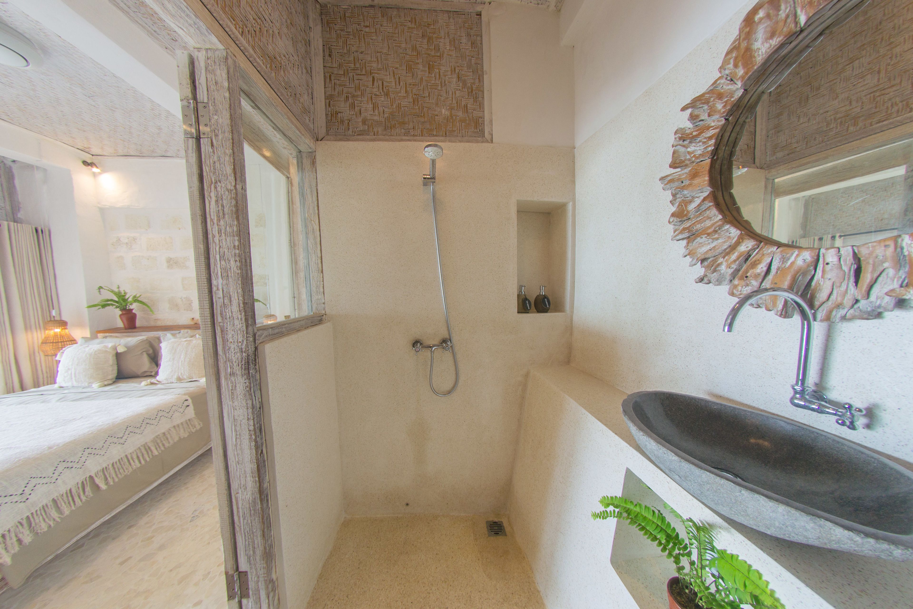A bathroom with a shower, a sink, and a mirror.