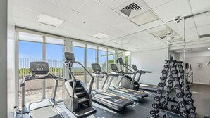 A gym with treadmills, weight machines, and free weights.