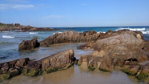 A rocky coastline with waves crashing against the rocks. - Sunset on Birubi, 2/40 Ocean Ave - pet friendly, air con, water views, WIFI and outdoor spa (Anna Bay)