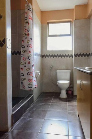 Bathtub, towels, soap, toilet paper