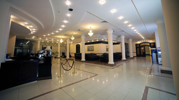 A spacious lobby with a reception desk, seating area, and a modern ceiling design. - Residence Park Hotel (Tashkent)