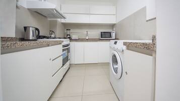 Apartment, Multiple Beds, Non Smoking | Private kitchen | Fridge, microwave, coffee/tea maker, cookware/dishes/utensils