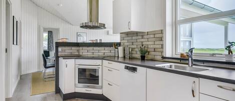 Fridge, stovetop, dishwasher, coffee/tea maker