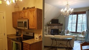 Una cocina con armarios de madera, microondas, horno y cafetera. Hay un comedor con mesa, sillas y candelabro.