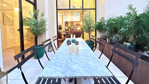 A dining area with a marble table, chairs, and potted plants. - Sparissimo, 6 Br / 4 Ba, 14 ppl, 220 m² (Paris)