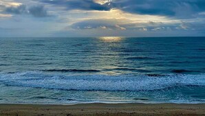 A beach with waves and a cloudy sky. - Ocean Front Community- Ocean Village at South Hutchinson Island- Treasure Coast (Fort Pierce)