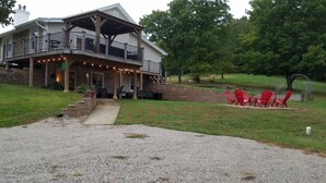 A two-story house with a covered porch and outdoor seating area. - Pet Friendly, Scenic, Eureka, St Louis, Nurse, Insurance, Contractor spec. rates (High Ridge)