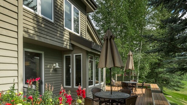 A deck with outdoor furniture, a pergola, and a garden with flowers. - Fairway Nine Town Home Retreat Sun Valley (Sun Valley)