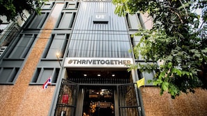 A building entrance with a sign reading "US #THRIVETOGETHER" and "ONSPACE THAILAND". - The CAPSULE by UnionSPACE - Adults Only (Bangkok)