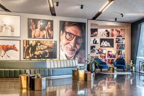 A modern lobby with a seating area, wall art, and a coffee table. - Crystalbrook Vincent (Brisbane)