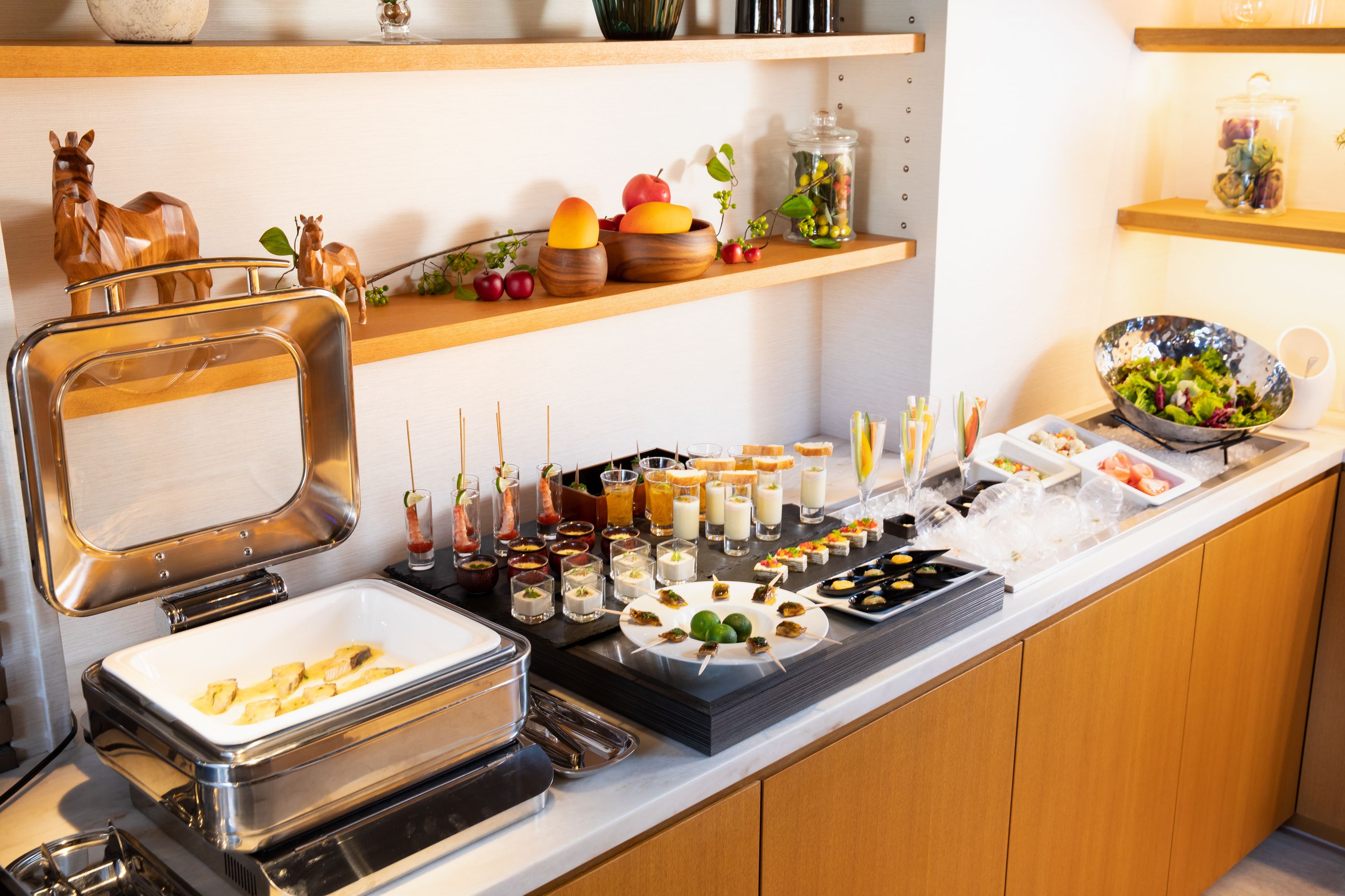 A buffet setup with various food items and drinks.