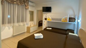 A hotel room with a large bed, a bedside table, a TV, and a window with curtains. - Hotel Major (Cervia)
