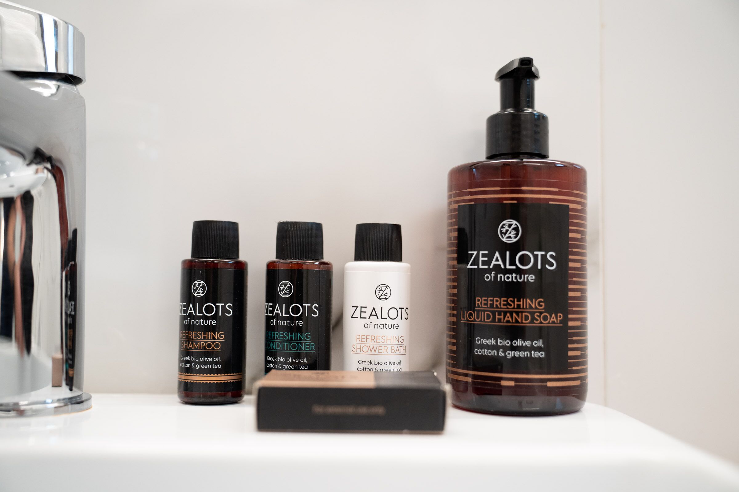 designer toiletries, hair dryer, slippers, towels