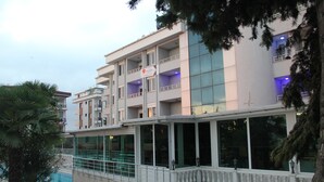 A multi-story building with balconies, large windows, and a pool area. - Ata Hotel Kumburgaz (Istanbul)
