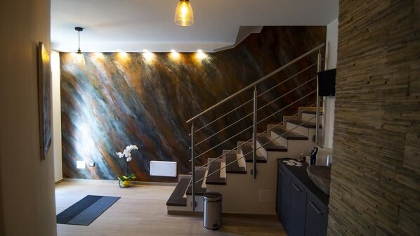 A modern interior with a staircase, a wooden accent wall, and a minimalist design. - B&B Terra Mare (Trecchina)