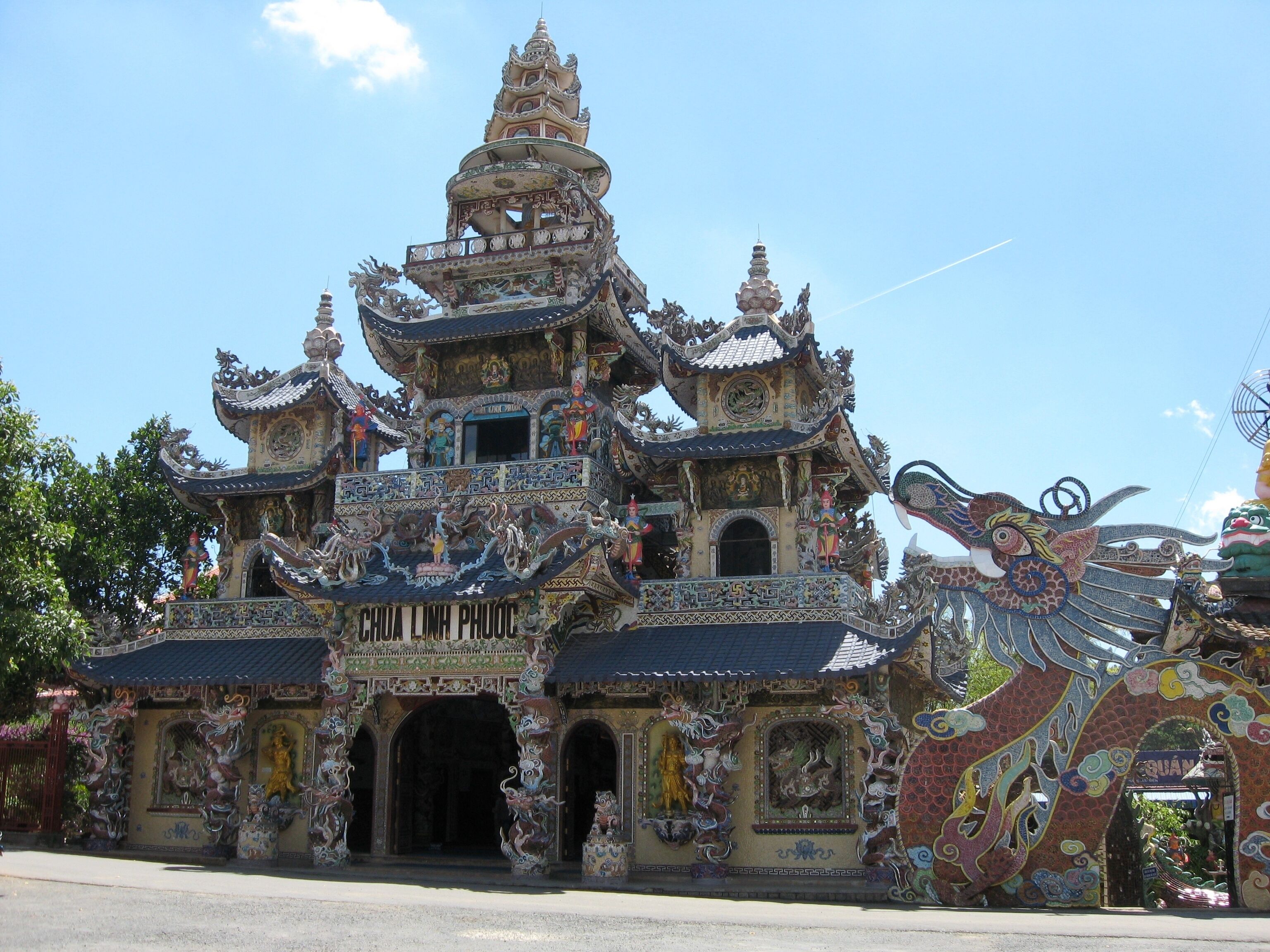 A traditional multi-tiered temple with ornate decorations and statues.