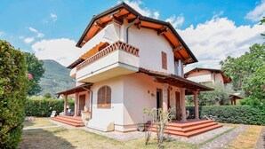 A two-story house with a balcony, stone steps, and a garden. - Nice home in Camaiore -LU- with private swimming pool, can be inside or outside (Camaiore -LU-)