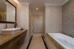 A modern bathroom with a large sink, a bathtub, and a shower area. - Hanoi Central Hotel & Residences (Hanoi)