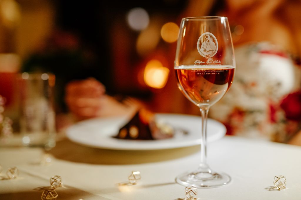 A wine glass with a label on a table.