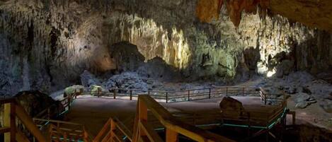 A cave interior with wooden walkways and a viewing platform.