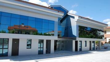 A modern building with large glass windows and a flat roof.