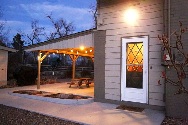 Relax in this serene outdoor space with a bench and picnic table, perfect for dining or unwinding.