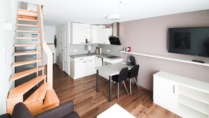 A modern apartment with a kitchen, dining area, and living room. - Neckarzeit (Neckarwestheim)
