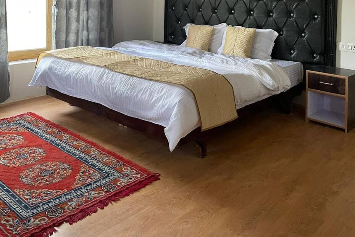 Habitación Deluxe | Escritorio, camas supletorias, ropa de cama
