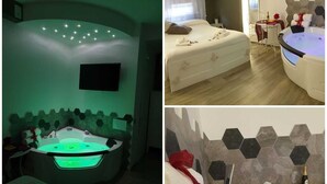 A spa room with a large tub, a smaller tub, and a shower area. There are towels and toiletries on the floor. - Il Mare di Roma Luxury (Rome)