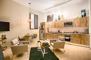 A modern kitchen with wooden cabinets, a built-in microwave, and a stainless steel refrigerator.