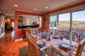 Enjoy meals in this dining area with a glass table and comfortable seating for a scenic view.