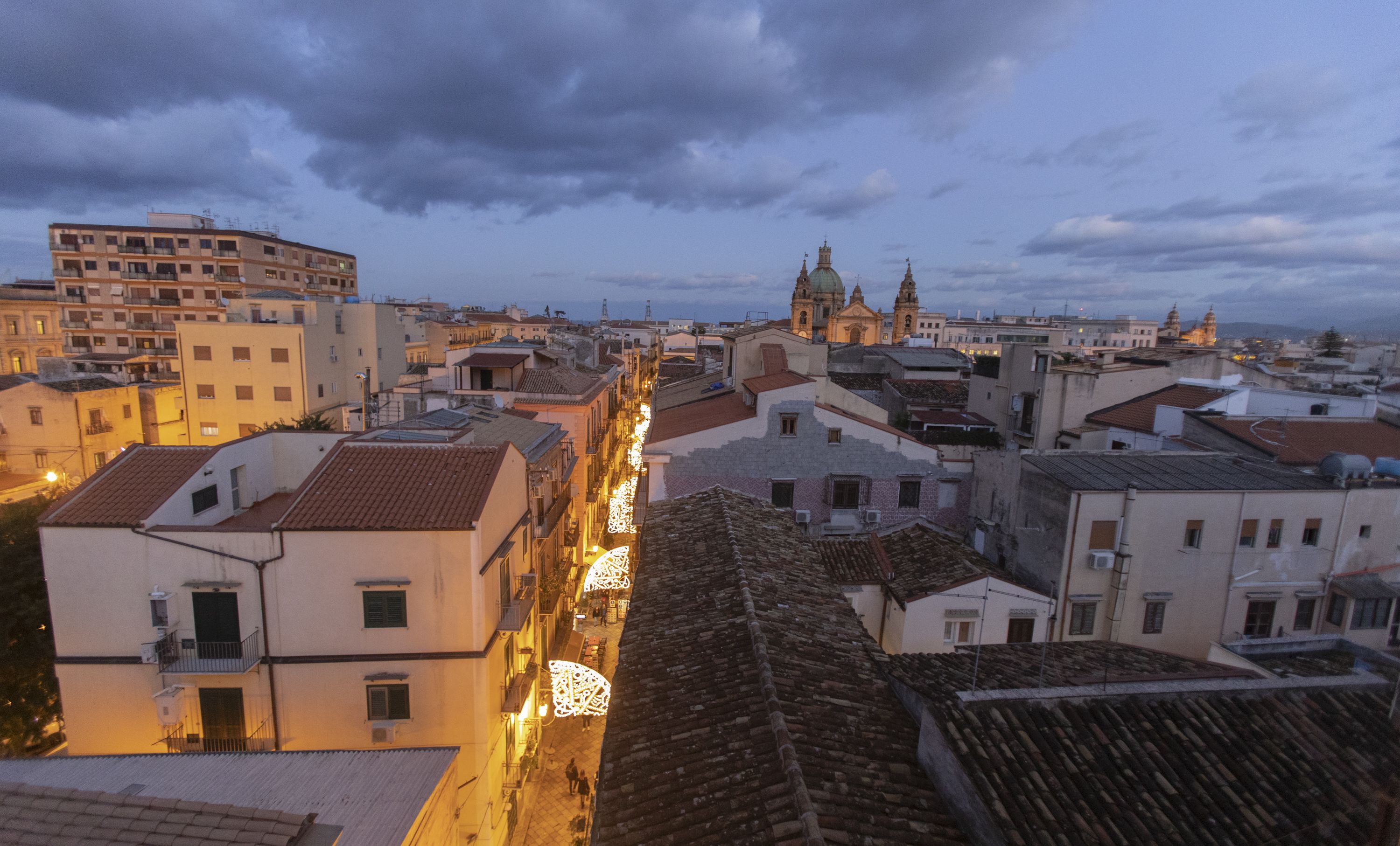 A cityscape with historic buildings, a prominent church, and a modern high-rise.